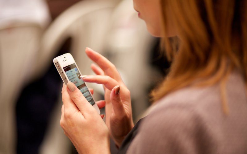 Woman Typing on Phone